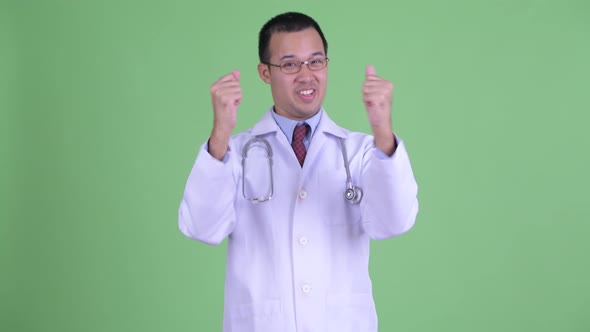 Happy Asian Man Doctor with Eyeglasses Getting Good News alt
