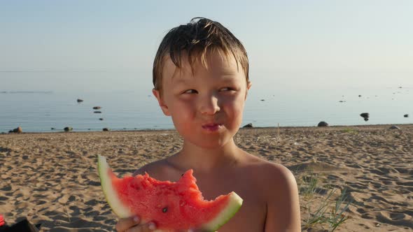 Little Boy Eating a Juicy Watermelon on the Beach