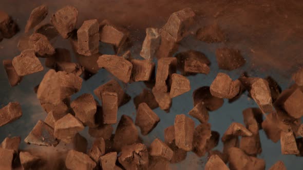 Super Slow Motion Shot of Flying Raw Chocolate Chunks and Cocoa Powder at 1000 Fps alt