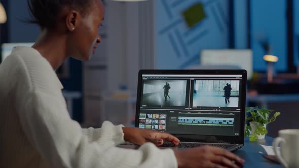African Videographer Working at Laptop From Office Editing Video Project alt