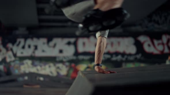 Sporty Man Performing Jump Tricks on Roller Skates at Urban Skate Park alt