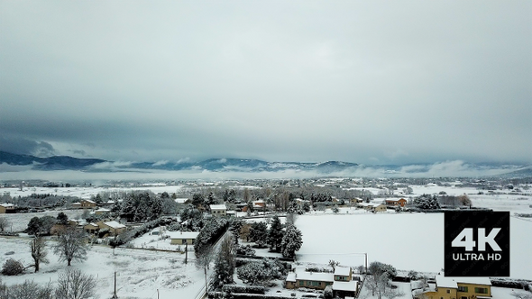 Aerial View of Snowy French Village and Mountains
