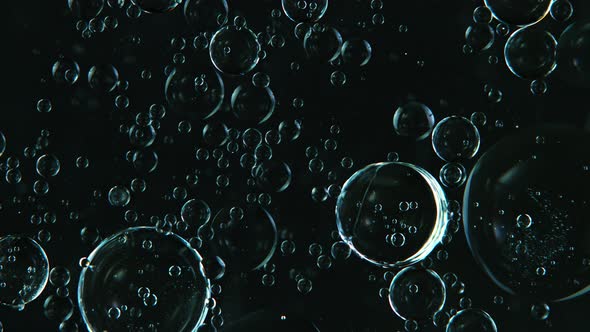 Super Slow Motion Shot of Moving Blue Bubbles Isolated on Black Background at 1000Fps alt
