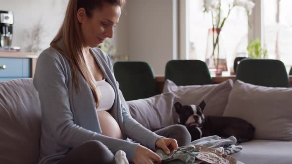 Pregnant woman prepare baby clothes. Shot with RED helium camera in 8K alt