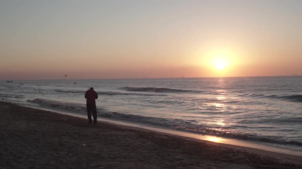 a Man Slowly Walks Along the Shore of the Warm Black Sea
