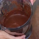 A Woman Demonstrates A Banana Chocolate Smoothie. In A Blender Bowl. Shot Close Up.