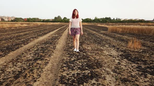 Girl Walks in Burnt Wheat Field alt