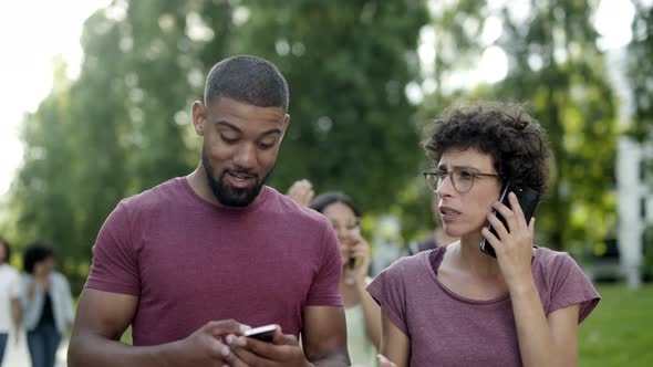 Smiling Curly Woman in Eyeglasses Talking on Smartphone alt