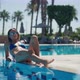 Cute Beautiful Girl Sitting Near the Pool - VideoHive Item for Sale