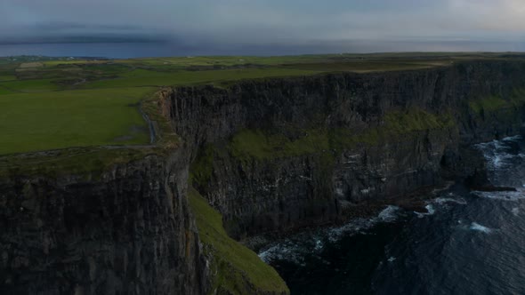 Tilt Up Reveal on High Rock Cliffs Above Sea Surface alt