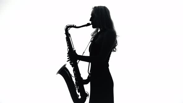 Musician Woman Playing on Saxophone