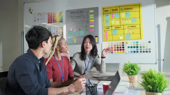 Businessman creative designers present work to the team.Designers a meeting in a modern office.