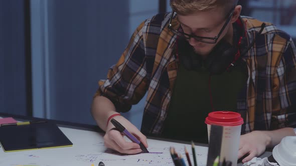 Creative Designer with Headphones Makes Sketches, Creative Process