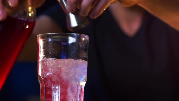Hands of Male Bartender Preparing a Cocktail Drink and Mixes It Up alt