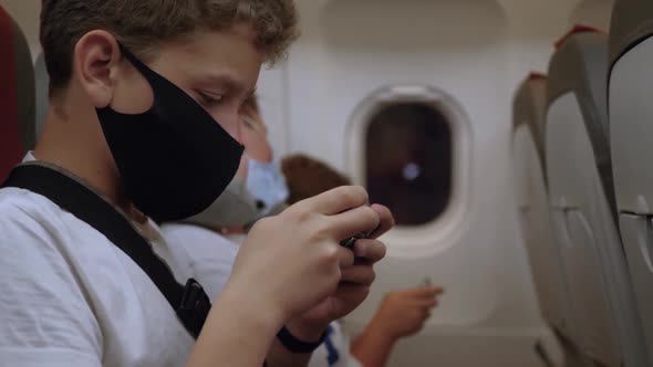 Teen in Mask on Airplane