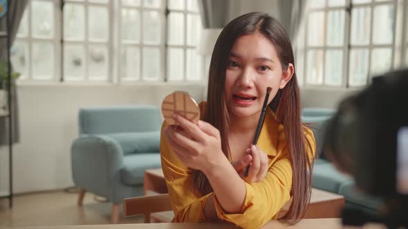Beauty Blogger Woman Filming Daily Make-Up Routine Tutorial At Camera On Tripod alt