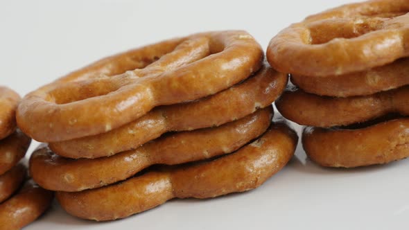 Panning on tasty pretzel snack  on white background  4K 2160p 30fps UltraHD footage - Slow pan baked alt
