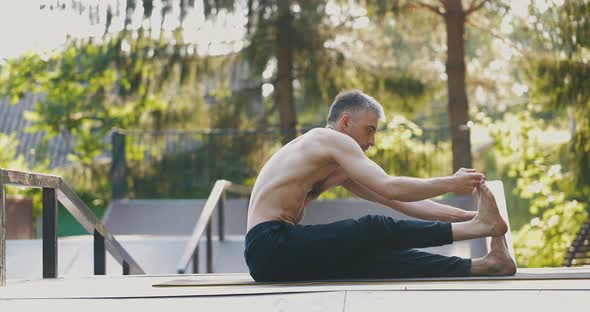 Man Warming Up Body Before Yoga Practice alt