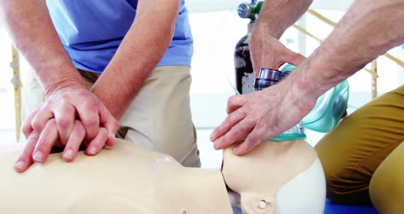 Male paramedic during cardiopulmonary resuscitation training alt