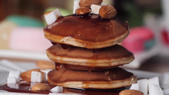 Breakfast. Syrup Pours on the Pancake Nice and Slow. Slow Motion. Bright Blurred Background. Tasty