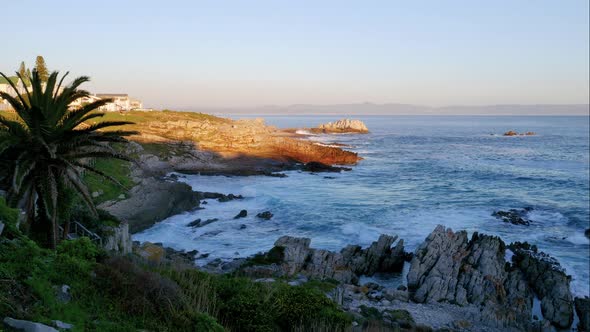Timelapse of waves rolling in to bay with very rocky shore in the beautiful Hermanus, South Africa. alt