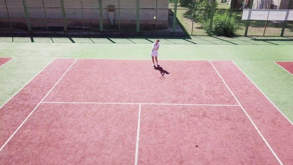 People Playing Tennis on Court in Summer