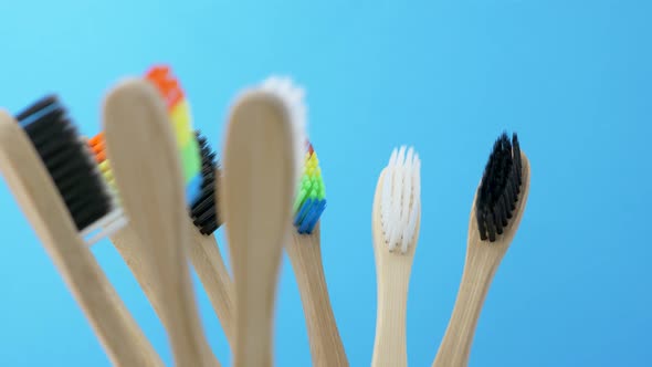 Colorful Toothbrushes Is Spinning on Blue Background alt