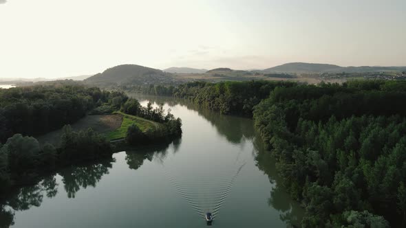 a small motorboat going slow on a small canal on the Danube alt