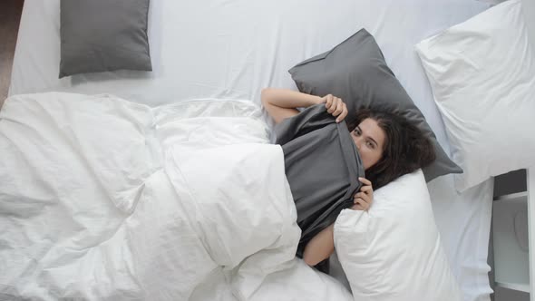 Young Flirty Woman Posing for Camera in Bed in the Morning alt