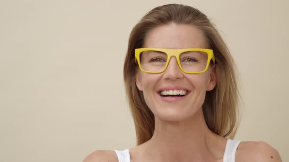 Lady with Big Yellow Glasses Laughing at the Camera