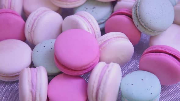 Color desert macaron lies on the festive table. Drive-through close-up shot