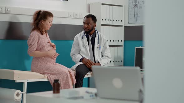 Patient Expecting Child Meeting with Physician in Medical Cabinet alt