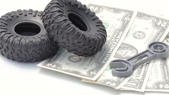 one back tire is rolling on dollars.car repair and maintenance,tires replacement. alt