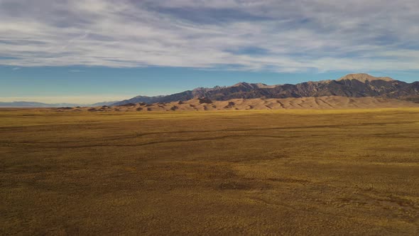 Great Sand Dunes Colorado Mountains Sunset Aerial Pan Shot 4K alt