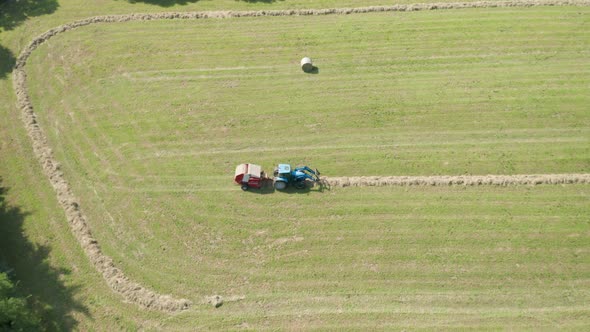 Blue Tractor Hay Bales Trees Aerial View