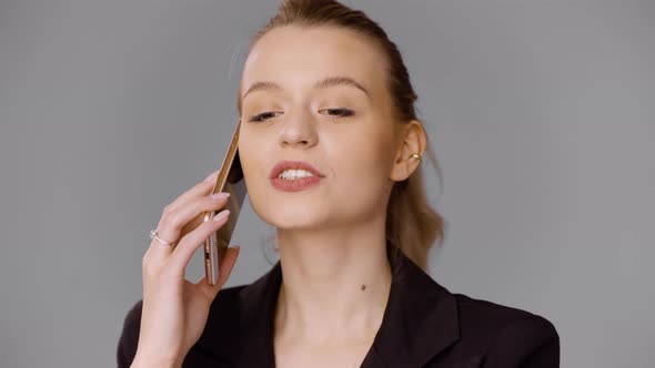Female Entrepreneur Talking on Smartphone in Studio alt