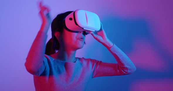 Woman looking though VR device with red and blue light