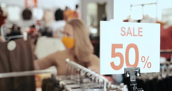 Clothing Store Banner with Discount Amount and People in Masks Choosing Clothes