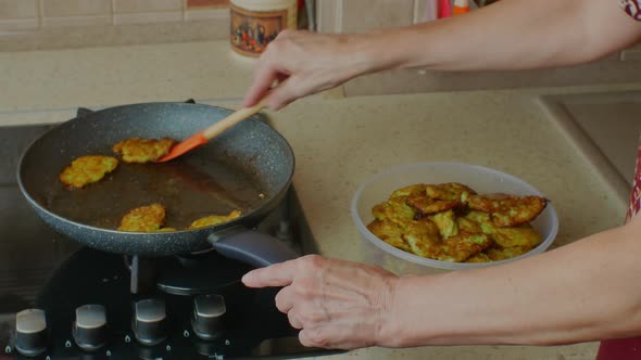 A Woman Puts Already Fried Cutlets From a Frying Pan Into a Bowl