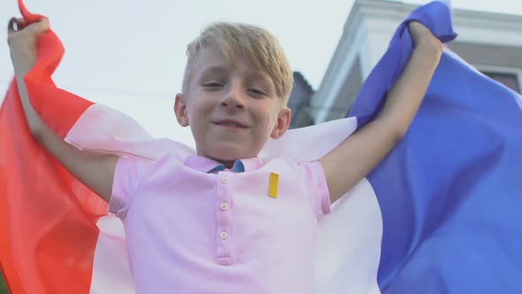 Cheerful Child Patriot With French Flag Looking Camera, Rooting for Sport Team