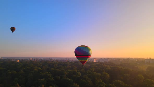 Aerial Drone View of Colorful Hot Air Balloon Flying Over Green Park and River in Small European alt