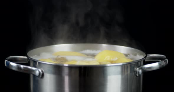 Potatoes Boiling in a Pot with Air Bubbles and Hot Steam  alt