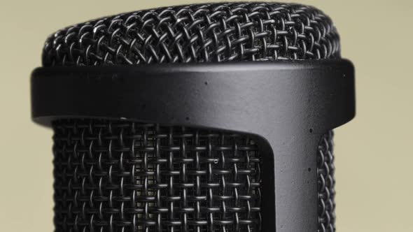 Studio Condenser Microphone Rotates on Yellow Background with Place for Text alt