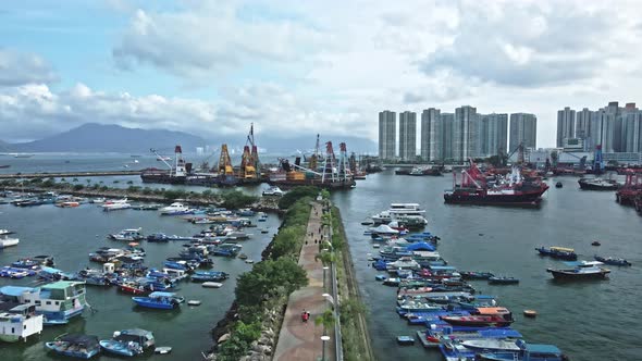 Drone shot of Typhoon shelter in Tuen Mun, Hong Kong where yacht, ships are seen idling on the sea alt