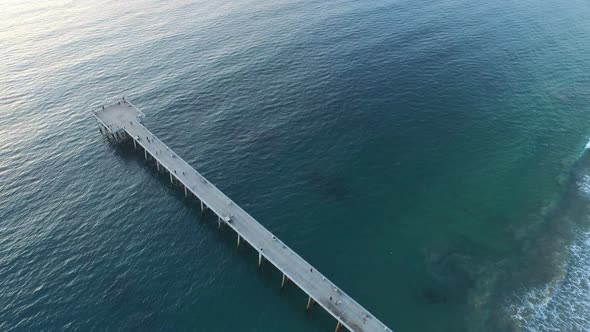 Aerial shot of a scenic beach city and ocean at sunset. alt