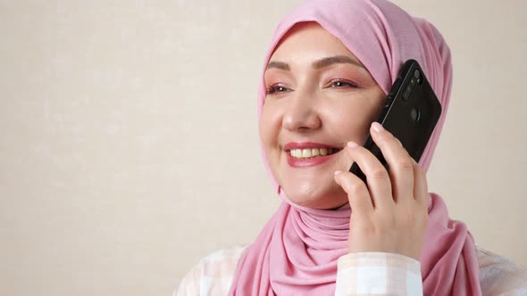 Young Caucasian Muslim Woman Talking on the Phone alt