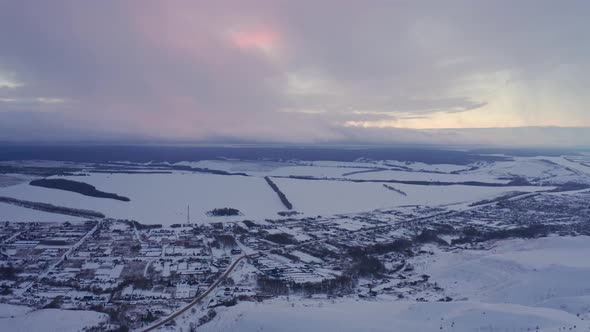 Russian Village in Winter Under a Bright Cloudy Sky