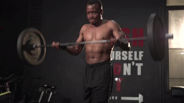 Young african sportsman lifting a barbell weight, Fitness man lifting weights in gym fitness