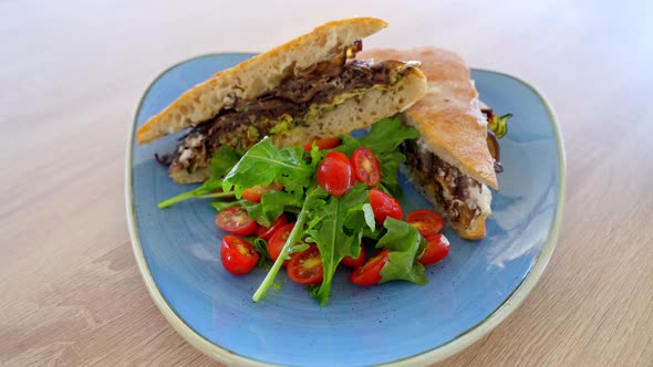 Delicious Ciabatta Sandwich Bread, Grilled Eggplants, Zucchini And Cherry Tomatoes On Plate. Hand He alt