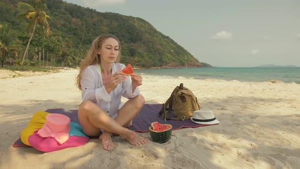 The Cheerful Woman in Holding and Eating Slices of Watermelon on Tropical Sand Beach Sea alt